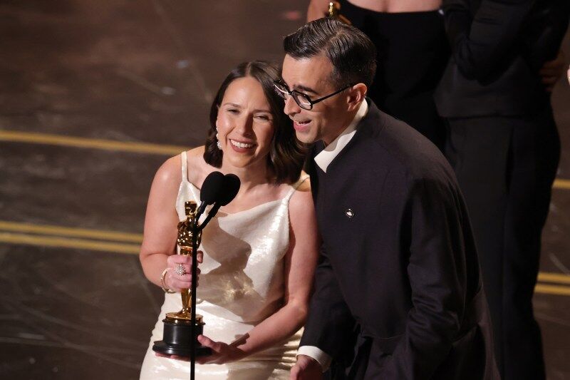 HOLLYWOOD, CALIFORNIA - MARCH 15: (L-R) Natalie Musteata and Alexandre Singh accept the Live Action Short Film award for "Two People Exchanging Saliva" onstage during the 98th Oscars at Dolby Theatre on March 15, 2026 in Hollywood, California. (Photo by Kevin Winter/Getty Images)